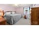 Tranquil bedroom with soft pink walls, a plush bed, and natural light offers a peaceful and relaxing environment at 207 N Sims St, Kings Mountain, NC 28086