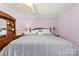 Spacious bedroom with a plush bed, natural light, and a ceiling fan provides a cozy and inviting atmosphere at 207 N Sims St, Kings Mountain, NC 28086