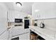 Efficient kitchen features white cabinets, updated appliances, and a breakfast bar area at 207 N Sims St, Kings Mountain, NC 28086