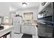 Classic kitchen with white cabinetry, tiled floors, and modern black appliances at 207 N Sims St, Kings Mountain, NC 28086