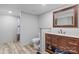 Bright bathroom with a wood vanity, granite countertop, toilet, and shower at 2154 Withers Dr, Maiden, NC 28650