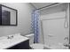 Bathroom with a white sink, blue vanity, and blue-patterned shower curtain at 2154 Withers Dr, Maiden, NC 28650