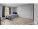 Cozy bedroom featuring wood-look flooring, a large window, and neutral paint to create a relaxing retreat at 2154 Withers Dr, Maiden, NC 28650