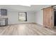Well-lit room with wood floors, open view to kitchen and sliding barn door at 2154 Withers Dr, Maiden, NC 28650
