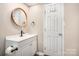 Bathroom featuring a modern vanity, round mirror, and sleek black hardware at 217 Cedarhurst Ln, Clover, SC 29710