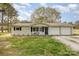 Charming single-story home with a two-car garage and a cozy front porch sitting area at 217 Cedarhurst Ln, Clover, SC 29710