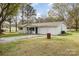 Single-story home with a two-car garage, comfortable front porch sitting area, and spacious yard at 217 Cedarhurst Ln, Clover, SC 29710