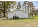 Side exterior view of a white one-story house with a covered patio and a well-maintained lawn at 217 Cedarhurst Ln, Clover, SC 29710