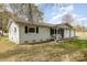 Single-story home with a two-car garage, comfortable front porch sitting area, and spacious yard at 217 Cedarhurst Ln, Clover, SC 29710