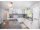 Well lit kitchen featuring granite countertops, white cabinets, stainless steel appliances, and luxury vinyl flooring at 217 Cedarhurst Ln, Clover, SC 29710