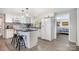 This spacious kitchen boasts white cabinets, black countertops, an island with seating, and stainless steel appliances at 217 Cedarhurst Ln, Clover, SC 29710