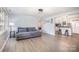 Spacious living room with plank floors adjacent to a white kitchen with a breakfast bar at 217 Cedarhurst Ln, Clover, SC 29710