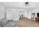 Open concept living room features plank floors adjacent to a white kitchen with a breakfast bar at 217 Cedarhurst Ln, Clover, SC 29710