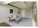 Cozy covered patio with a wicker loveseat and a table perfect for relaxation at 217 Cedarhurst Ln, Clover, SC 29710