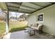 Covered patio with seating, offering a peaceful view of the spacious backyard at 217 Cedarhurst Ln, Clover, SC 29710