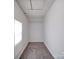 View of a small attic space with carpet, a window, and a ceiling access panel at 2300 Kennesaw Dr, Charlotte, NC 28216