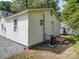 Backyard with a view of the exterior of the house and an air conditioning unit at 2300 Kennesaw Dr, Charlotte, NC 28216