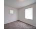 Bright bedroom with neutral carpet and a window at 2300 Kennesaw Dr, Charlotte, NC 28216