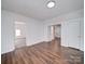 Bright, spacious room showcasing laminate flooring, fresh paint, and neutral colors at 2300 Kennesaw Dr, Charlotte, NC 28216