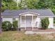 Charming home with manicured bushes and a welcoming front porch at 2300 Kennesaw Dr, Charlotte, NC 28216