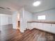Laundry room features a sink, white cabinets, wood-look floors, and washer/dryer hookups at 2300 Kennesaw Dr, Charlotte, NC 28216