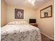 Modest bedroom with floral bedspread, dresser, mirror, and mounted television at 2401 Gelsinger Ave, Bessemer City, NC 28016