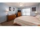 Cozy bedroom featuring a bed, dresser, ceiling fan and natural light at 2401 Gelsinger Ave, Bessemer City, NC 28016