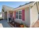 The side of a cozy home featuring red shutters and manicured landscaping at 2401 Gelsinger Ave, Bessemer City, NC 28016