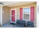Inviting front porch featuring a welcome sign, seating and lovely potted plants at 2401 Gelsinger Ave, Bessemer City, NC 28016