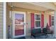 Inviting front porch featuring a welcome sign, seating and lovely potted plants at 2401 Gelsinger Ave, Bessemer City, NC 28016