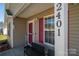 Inviting front porch featuring a welcome sign, seating and lovely potted plants at 2401 Gelsinger Ave, Bessemer City, NC 28016