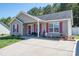 Inviting home with red shutters and a charming front porch with bench at 2401 Gelsinger Ave, Bessemer City, NC 28016