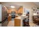 Modern kitchen featuring a bar area with bar stools, wooden cabinets and stainless appliances at 2401 Gelsinger Ave, Bessemer City, NC 28016