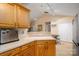 Bright kitchen showcasing wooden cabinets and a view into the dining area at 2401 Gelsinger Ave, Bessemer City, NC 28016