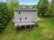 Exterior elevation of home with a spacious wooden deck and well-maintained lawn at 2717 Stockwood Dr, Gastonia, NC 28056