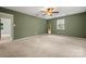 Spacious bedroom features neutral carpet, a ceiling fan, and a window at 2717 Stockwood Dr, Gastonia, NC 28056