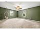 Bedroom features neutral carpet, natural light, and ceiling fan at 2717 Stockwood Dr, Gastonia, NC 28056