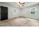 Bright bedroom features neutral carpet, two windows and ceiling fan at 2717 Stockwood Dr, Gastonia, NC 28056