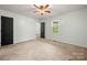 Bedroom featuring neutral carpet, two windows and ceiling fan at 2717 Stockwood Dr, Gastonia, NC 28056