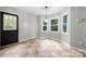 Sunlit breakfast nook features modern lighting and outdoor access at 2717 Stockwood Dr, Gastonia, NC 28056