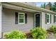Front entry of home features a green door with a window and gray siding at 2717 Stockwood Dr, Gastonia, NC 28056