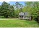 Two-story home with gray siding and black shutters on a spacious green lawn surrounded by mature trees at 2717 Stockwood Dr, Gastonia, NC 28056