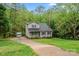 Two-story home with gray siding, black shutters, long driveway, and a storage building at 2717 Stockwood Dr, Gastonia, NC 28056