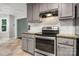 The well-lit kitchen is equipped with stainless steel appliances and gray cabinetry at 2717 Stockwood Dr, Gastonia, NC 28056