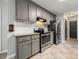 The well-lit kitchen is equipped with stainless steel appliances and gray cabinetry at 2717 Stockwood Dr, Gastonia, NC 28056