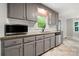 Well-lit kitchen features gray cabinets, granite countertops, and a stainless steel dishwasher at 2717 Stockwood Dr, Gastonia, NC 28056