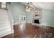 View of living room, stairs, and fireplace with hardwood floors and ceiling fan at 2717 Stockwood Dr, Gastonia, NC 28056