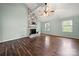 Bright living room featuring a brick fireplace, hardwood floors, and multiple windows for natural light at 2717 Stockwood Dr, Gastonia, NC 28056
