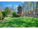 Spacious backyard with mature trees, providing ample room for outdoor activities at 2740 Cameron Commons Way, Matthews, NC 28104