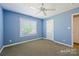 This bedroom has blue walls, carpet, a ceiling fan, and a window at 2740 Cameron Commons Way, Matthews, NC 28104